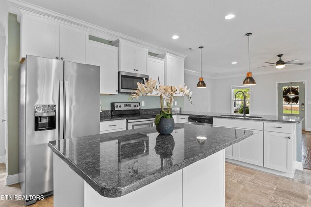 101 Fortenberry St, Oak Ridge, TN 37830 - kitchen featuring a sink, white cabinets, a peninsula, and stainless steel appliances