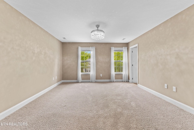 101 Fortenberry St, Oak Ridge, TN 37830 - empty room featuring baseboards, a chandelier, and carpet floors