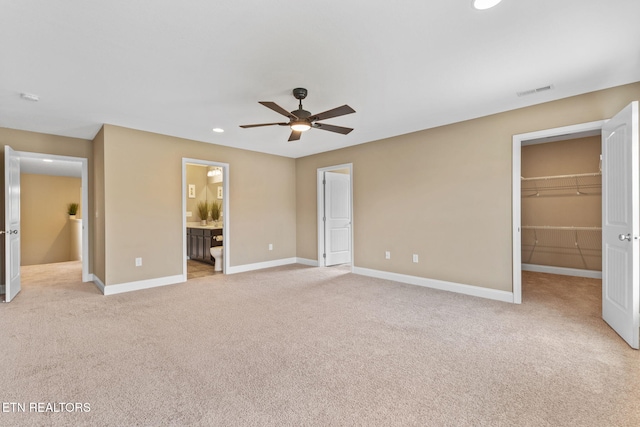 101 Fortenberry St, Oak Ridge, TN 37830 - unfurnished bedroom featuring a walk in closet, baseboards, light carpet, and recessed lighting