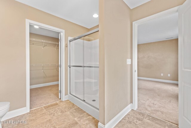 101 Fortenberry St, Oak Ridge, TN 37830 - bathroom featuring baseboards, a spacious closet, a stall shower, and toilet