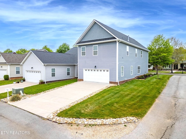 101 Fortenberry St, Oak Ridge, TN 37830 - view of side of home with a garage, concrete driveway, and a lawn