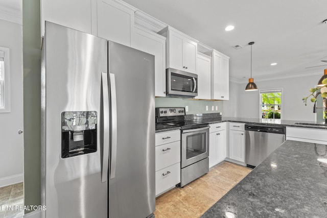101 Fortenberry St, Oak Ridge, TN 37830 - kitchen featuring appliances with stainless steel finishes, crown molding, white cabinets, and dark stone countertops