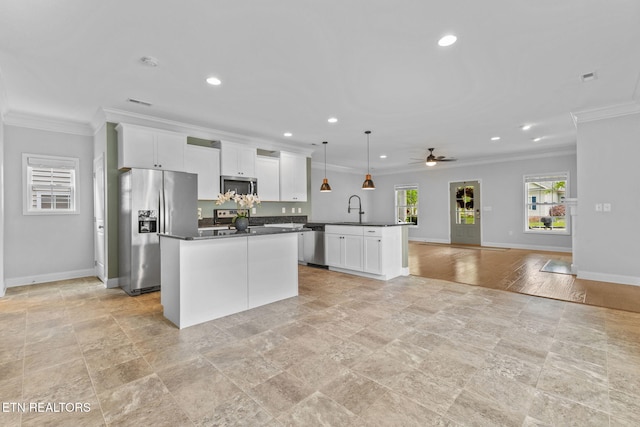 101 Fortenberry St, Oak Ridge, TN 37830 - kitchen with recessed lighting, stainless steel appliances, a center island, ornamental molding, and dark countertops