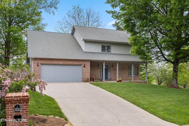 traditional-style house with covered porch, brick siding, a garage, a front lawn, and concrete driveway