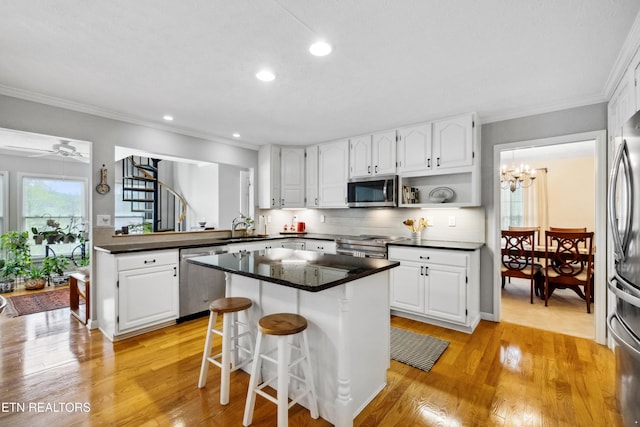 kitchen with white cabinetry, appliances with stainless steel finishes, and a sink
