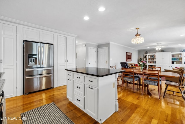 kitchen featuring recessed lighting, stainless steel fridge, light wood-style floors, and crown molding