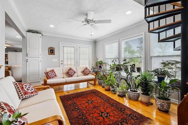 living room with crown molding, recessed lighting, a ceiling fan, and wood finished floors