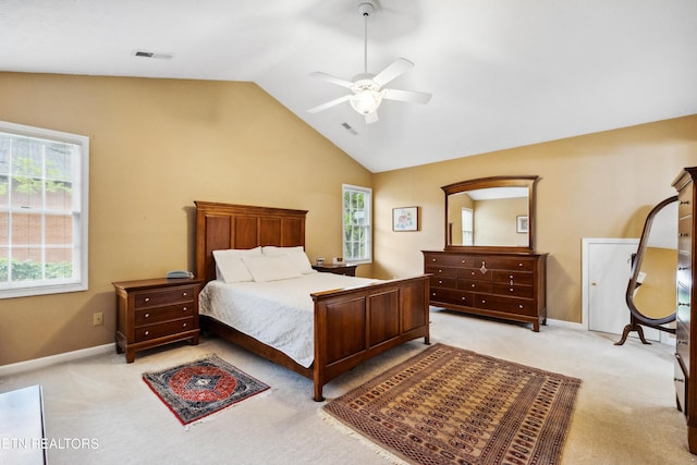 bedroom featuring lofted ceiling, visible vents, baseboards, light carpet, and a ceiling fan