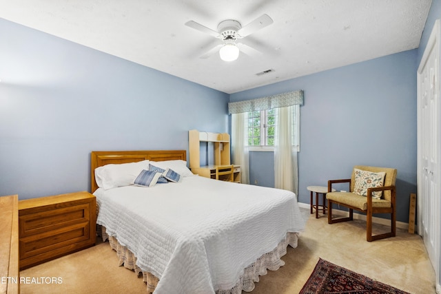 bedroom featuring carpet, visible vents, a ceiling fan, and baseboards