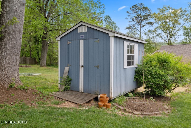 view of shed with fence
