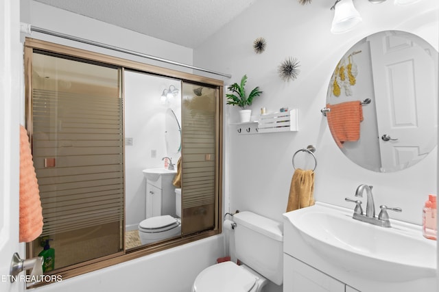 full bathroom with toilet, combined bath / shower with glass door, vanity, and a textured ceiling