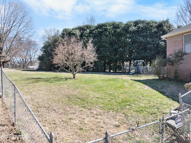 view of yard with a fenced backyard and a playground