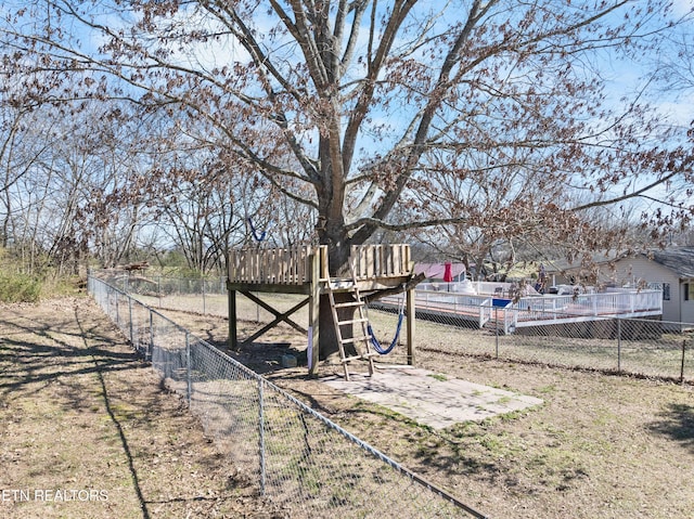 view of yard featuring a wooden deck and fence