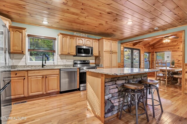 3131 Valley Home Rd, Sevierville, TN 37862 - kitchen featuring a sink, stainless steel appliances, wooden ceiling, light wood-type flooring, and a breakfast bar