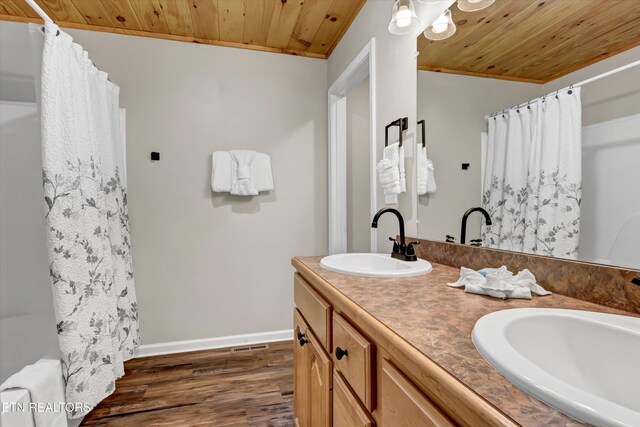 3131 Valley Home Rd, Sevierville, TN 37862 - full bath featuring wood ceiling, baseboards, wood finished floors, curtained shower, and double vanity