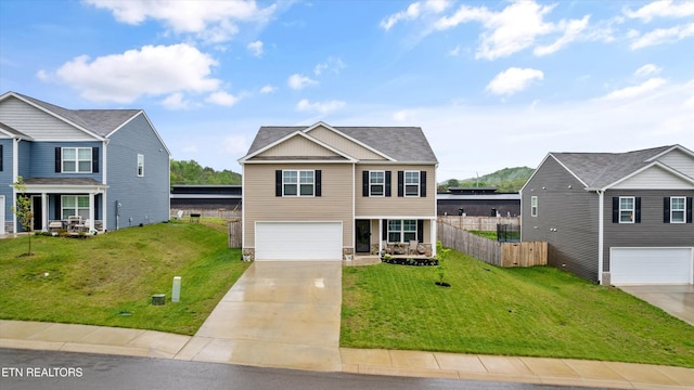 view of front of property featuring a garage, fence, driveway, and a front yard