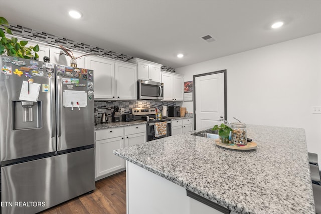 kitchen featuring visible vents, recessed lighting, white cabinetry, a sink, and stainless steel appliances