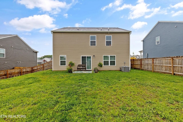 back of property with a lawn, a patio, and a fenced backyard