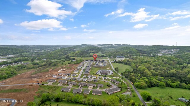 drone / aerial view featuring a residential view and a mountain view