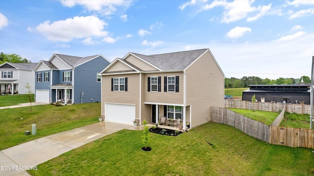 view of front facade featuring an attached garage, a front lawn, fence, and concrete driveway