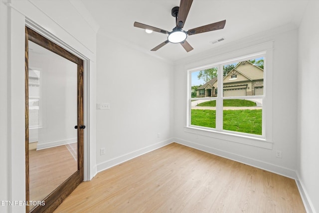 unfurnished room with baseboards, ceiling fan, light wood-type flooring, and visible vents