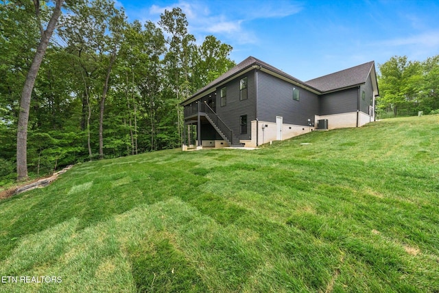 view of yard with stairs and a deck