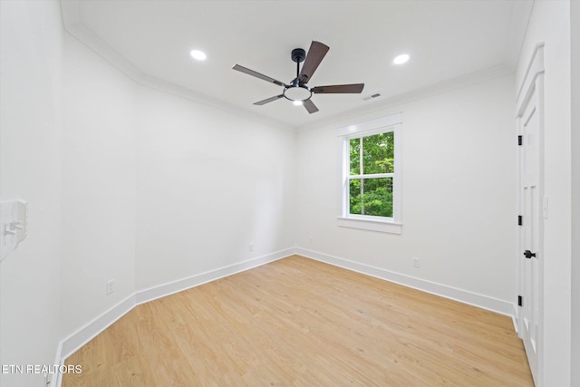 empty room featuring ceiling fan, visible vents, baseboards, and light wood-style floors