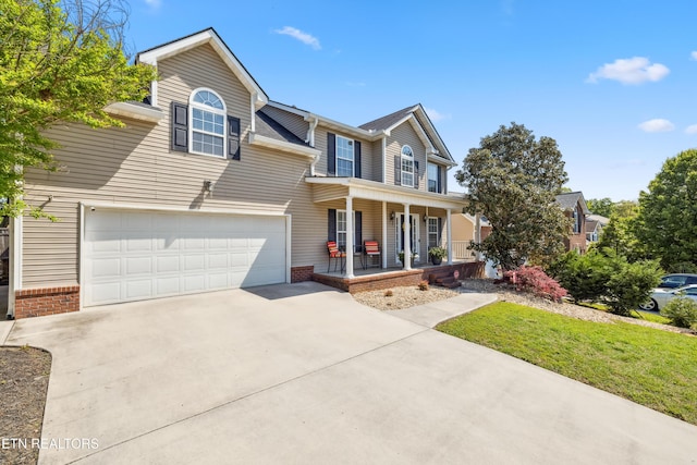 traditional-style house with covered porch, driveway, a front lawn, and brick siding