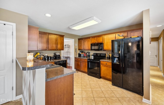 kitchen featuring brown cabinets, a peninsula, recessed lighting, light tile patterned floors, and black appliances