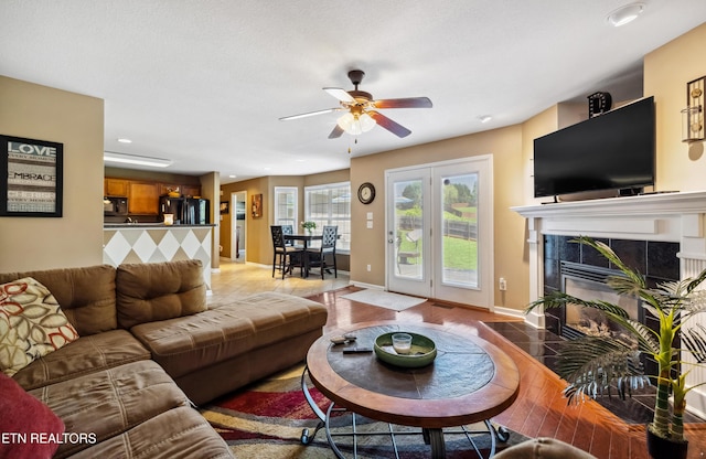 living room with recessed lighting, baseboards, ceiling fan, and a fireplace