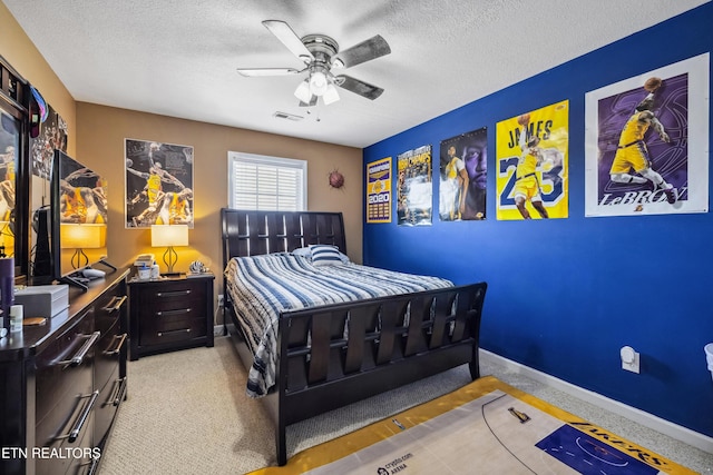 bedroom with baseboards, a ceiling fan, a textured ceiling, and visible vents