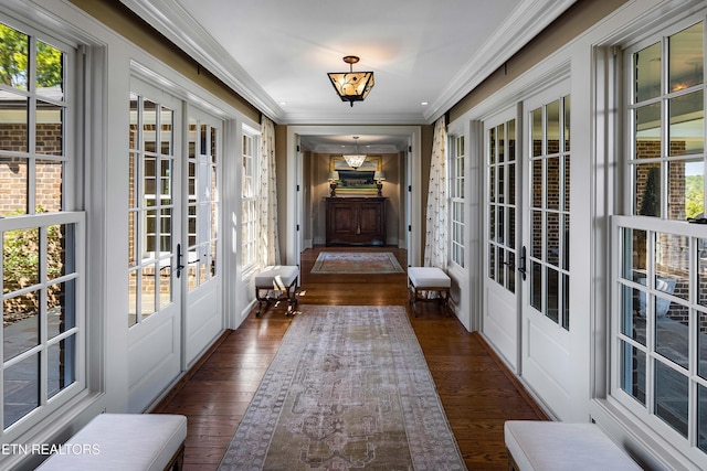 interior space featuring wood finished floors, french doors, and ornamental molding