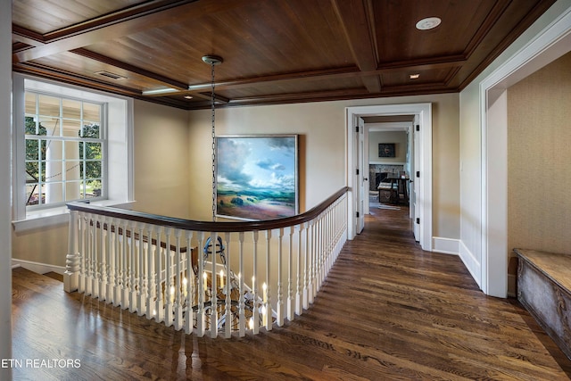 corridor featuring baseboards, ornamental molding, coffered ceiling, and dark wood finished floors
