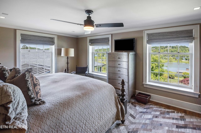bedroom featuring ornamental molding, a ceiling fan, and baseboards