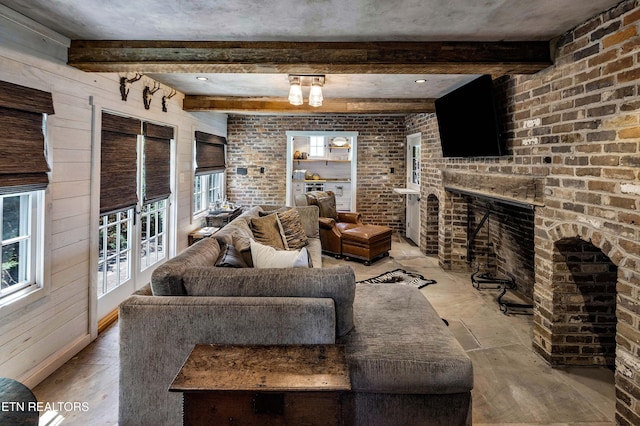 living room with beamed ceiling, a fireplace, and light wood finished floors