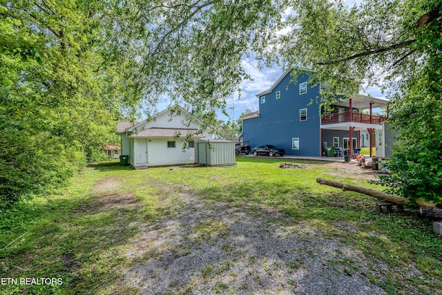 view of yard with an outbuilding, a patio, and a storage unit