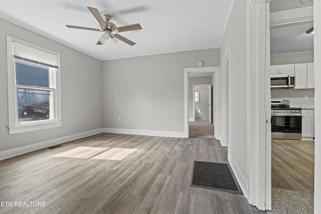 interior space with a ceiling fan, light wood-style flooring, and a healthy amount of sunlight