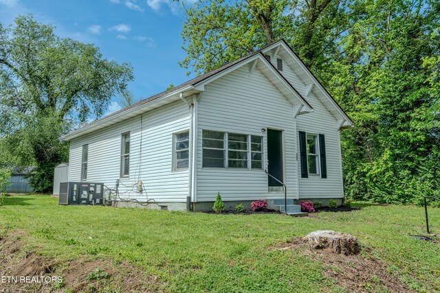 exterior space with a lawn and entry steps