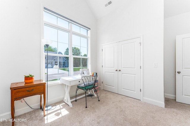 home office featuring carpet floors, baseboards, visible vents, and high vaulted ceiling