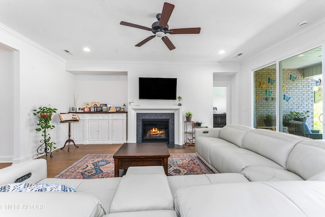 living area with recessed lighting, ornamental molding, dark wood finished floors, and ceiling fan