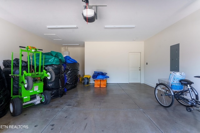 garage with a garage door opener and electric panel
