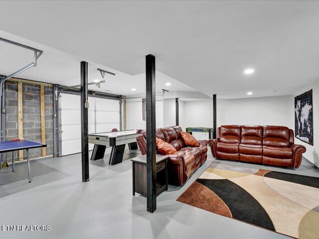 living area with a garage, finished concrete floors, and recessed lighting