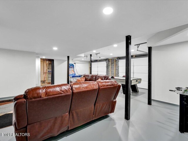 living area featuring recessed lighting and finished concrete floors