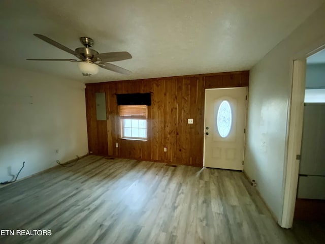 2789 Oak Grove Rd, Rocky Top, TN 37769 - foyer with wood finished floors, ceiling fan, wooden walls, and electric panel