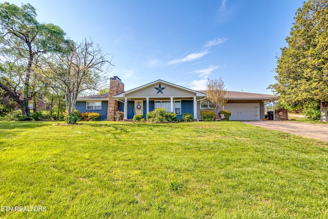 single story home featuring a front lawn, a chimney, an attached garage, and aphalt driveway
