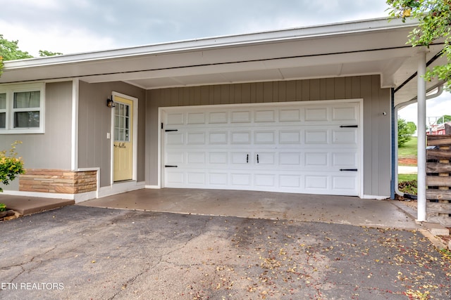 garage with aphalt driveway