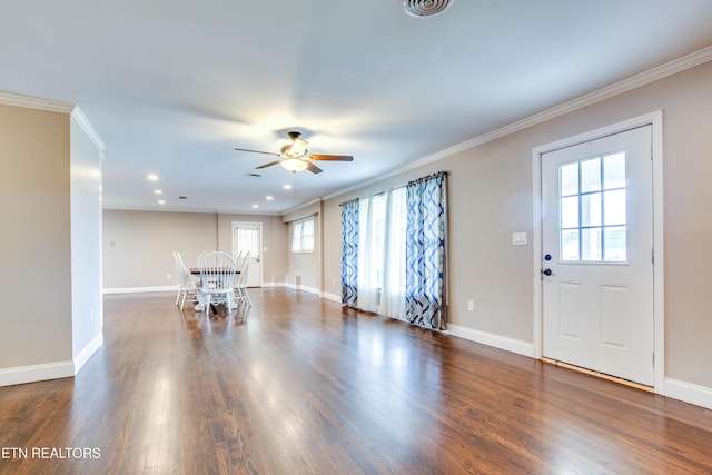 living area featuring crown molding, a ceiling fan, dark wood-style flooring, and baseboards