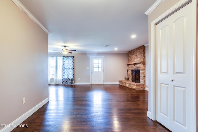 unfurnished living room featuring a fireplace, ornamental molding, and baseboards