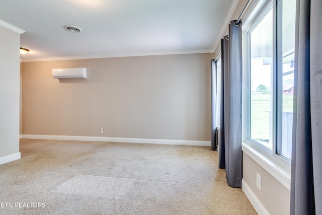 spare room featuring a wall mounted air conditioner, crown molding, visible vents, baseboards, and light colored carpet