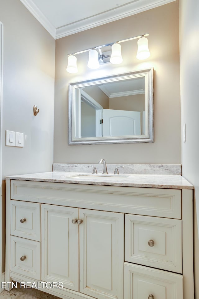 bathroom featuring crown molding and vanity